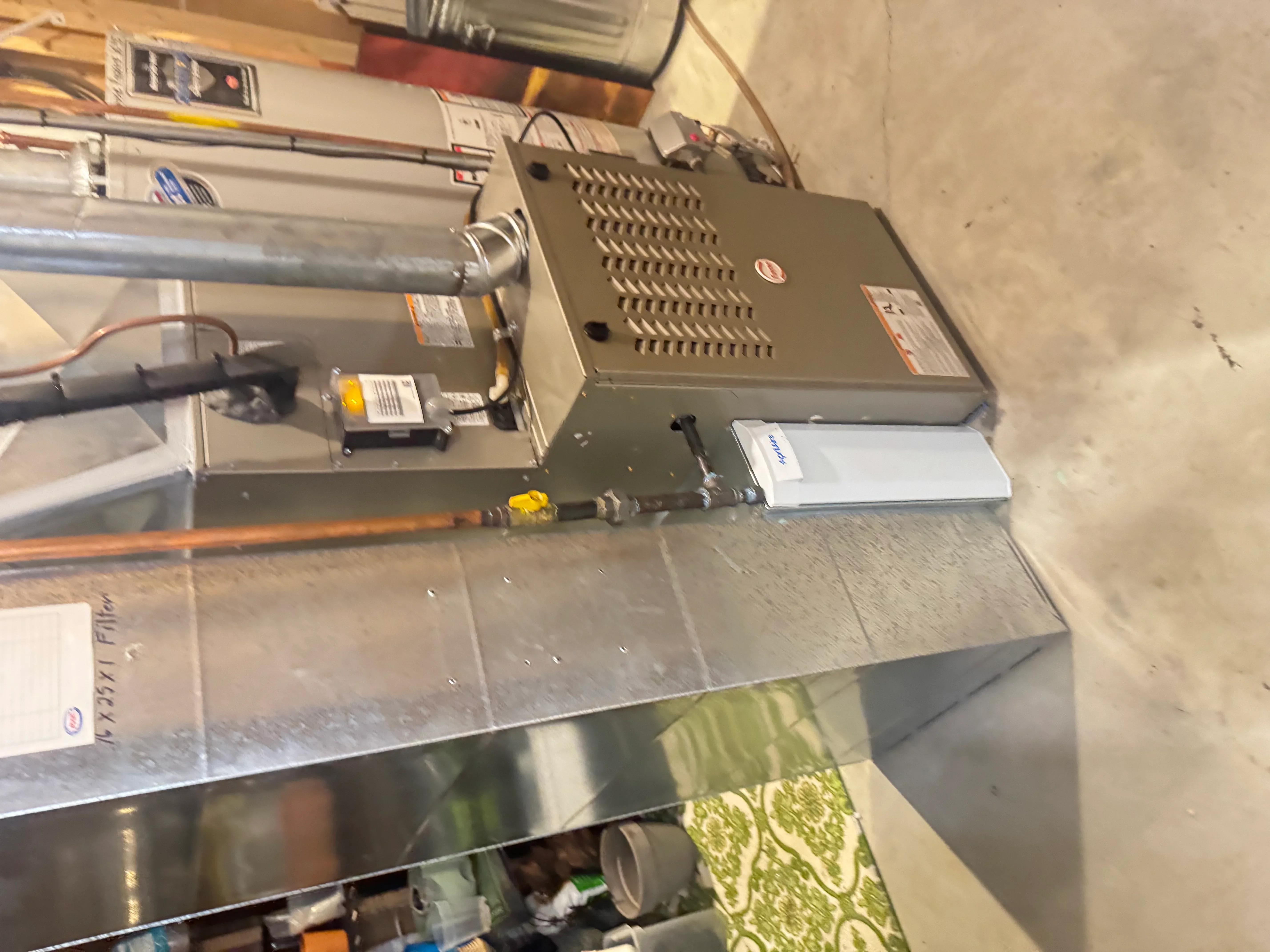 Electric furnace with metal housing, perforated heat exchanger, and connected ductwork installation