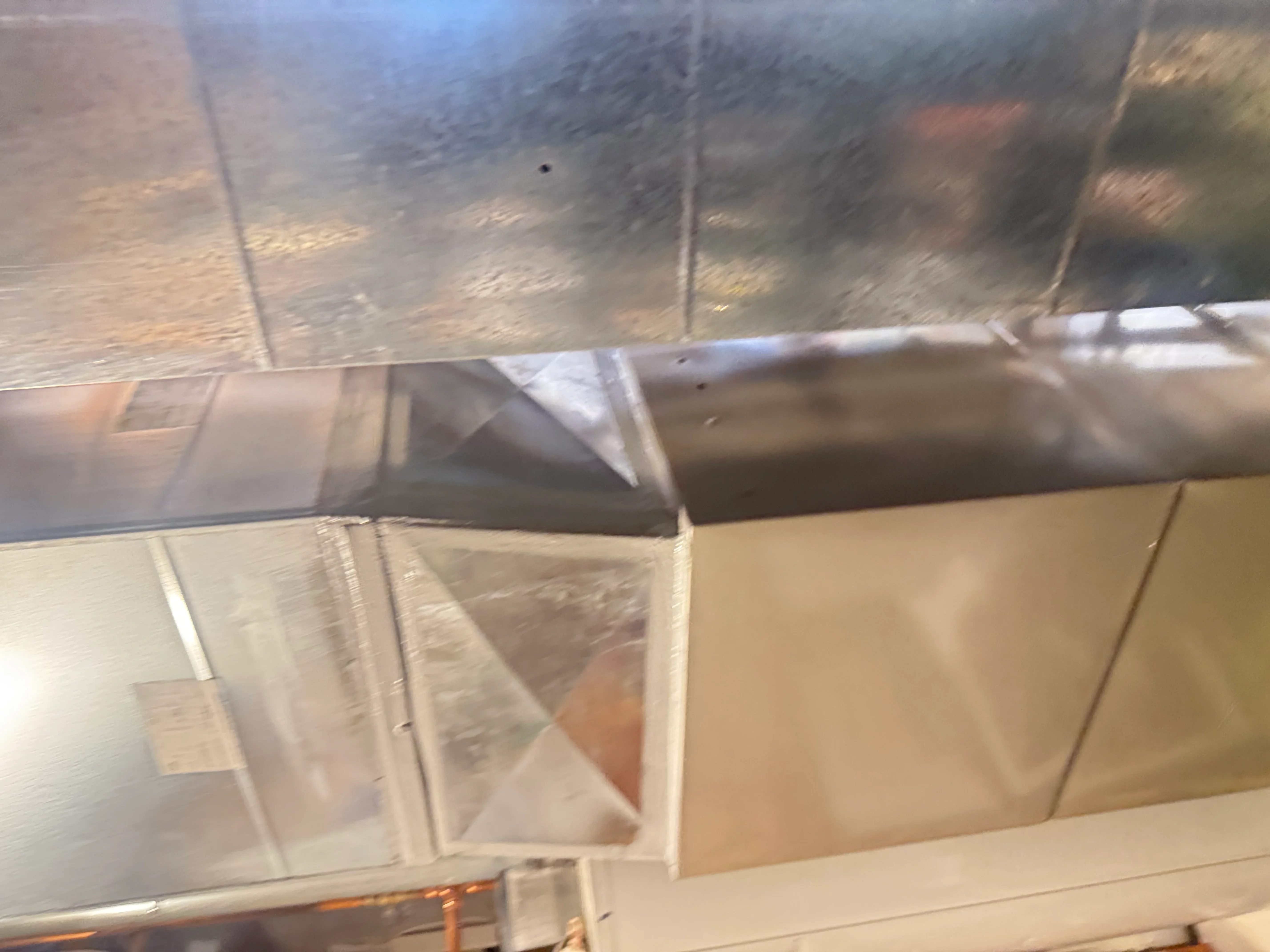 Metal ductwork with insulation wrap and sealed joints during HVAC installation