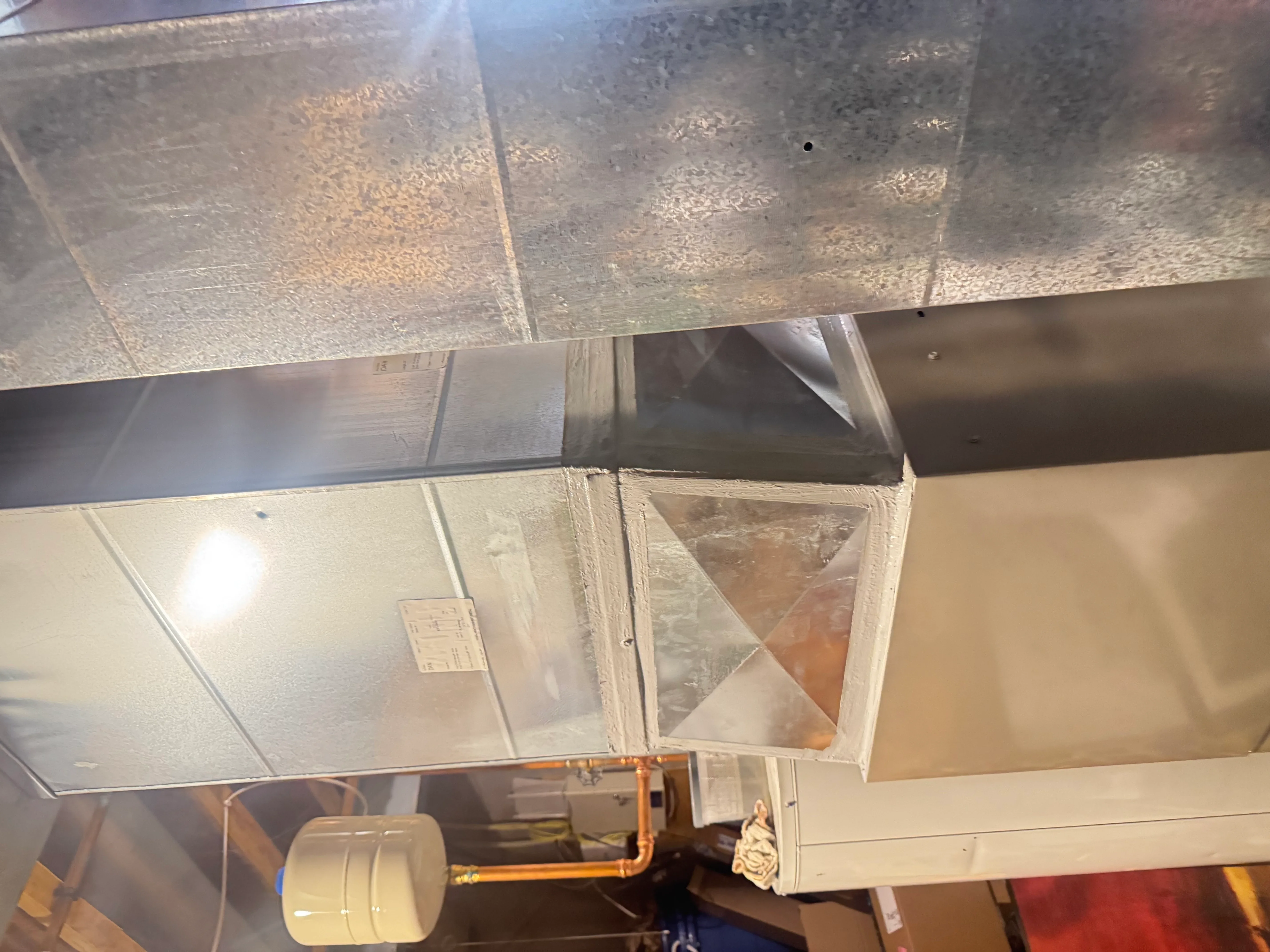 Metal ductwork with sealed joints and mastic sealant applied at connections