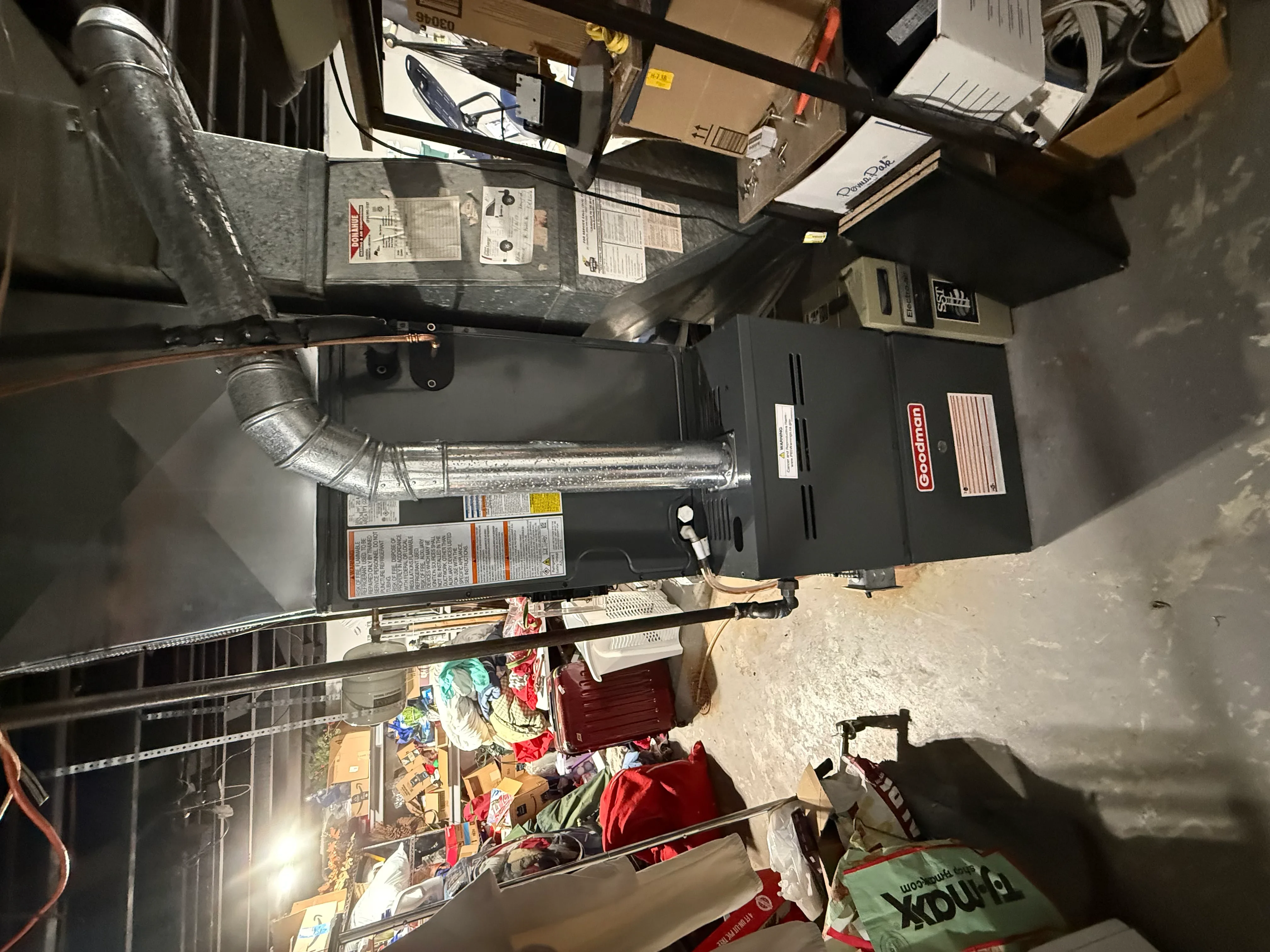 Gas furnace unit with metal ductwork and ventilation piping installed in utility space